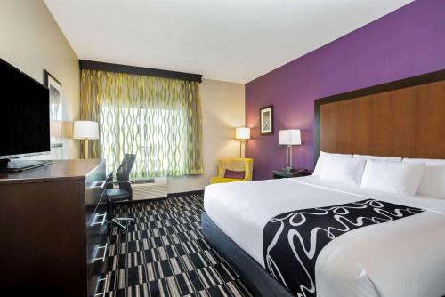 a hotel room with a large bed and a desk at La Quinta by Wyndham Cedar City in Cedar City