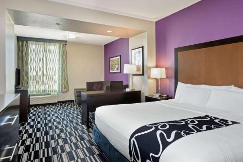 a hotel room with a large bed and a desk at La Quinta by Wyndham Cedar City in Cedar City