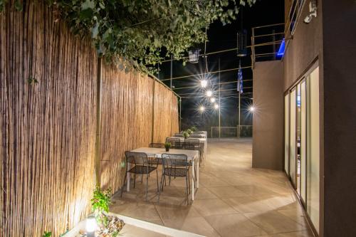 a row of tables and chairs in a restaurant at night at Hotel Palladium Sithonia in Kalamitsi