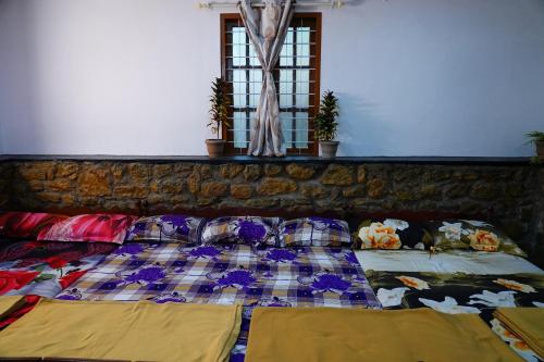 a bed with pillows on it in a room at Bison Valley Estate in Vālpārai