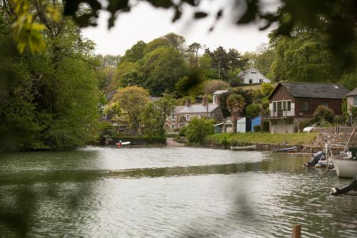 a river with houses on the side of a town at Navas Nook in Falmouth