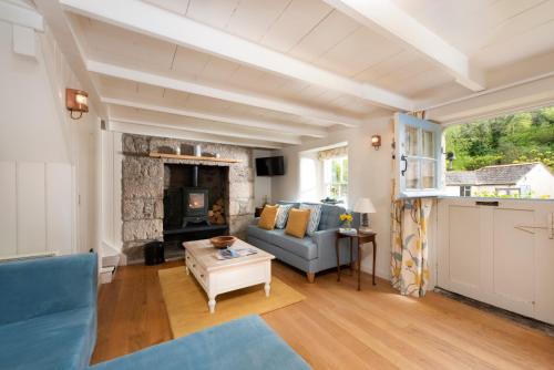 a living room with a couch and a fireplace at Navas Nook in Falmouth