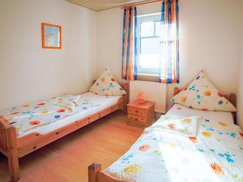 Un pat sau paturi într-o cameră la Ferienhof Kassandra