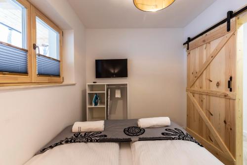 Posteľ alebo postele v izbe v ubytovaní TatryTop Apartamenty Alpejski SPA