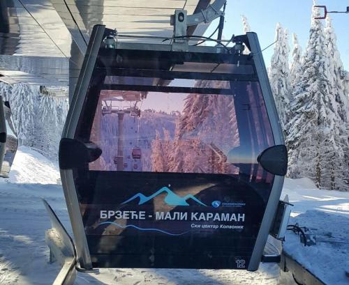 a sign on the back of a ski lift in the snow at GOski Apartman Brzeće Kopaonik in Brzeće