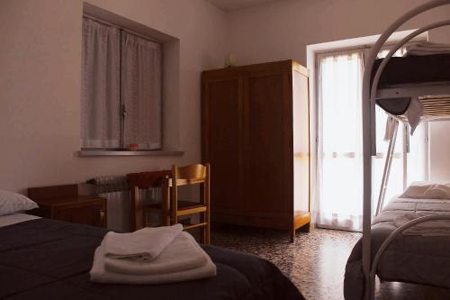 a room with a bedroom with a bed and a window at Casa per ferie BeatoRosaz in Cesana Torinese
