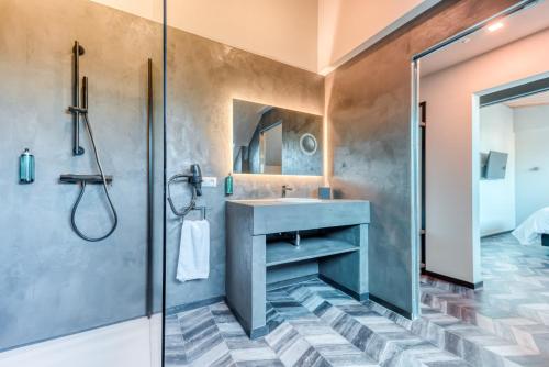 a bathroom with a sink and a shower at Les Chambres du Vieux Château in Abbaye dʼOrval