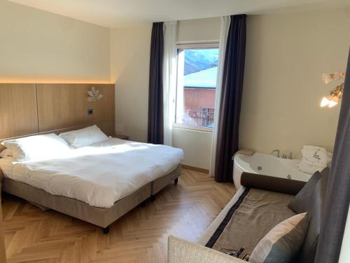 a bedroom with a large bed and a window at Hotel Firenze in Fanano