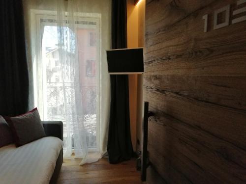 a bedroom with a bed and a large window at Hotel Firenze in Fanano