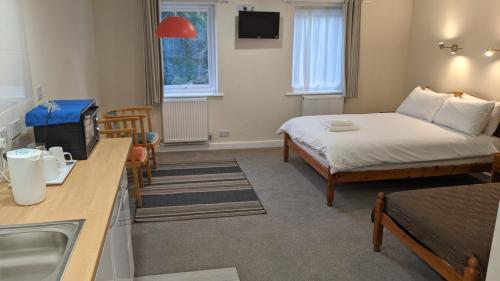 Postel nebo postele na pokoji v ubytování Ivybridge Guesthouse