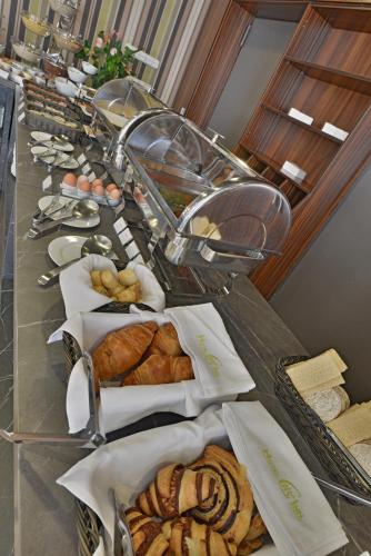 a buffet line of breads and pastries on a table at Hotel City Inn in Budapest