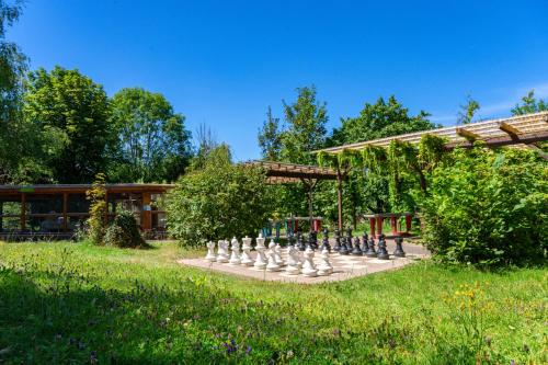 a large chess set in a garden in front of a building at Hotel Schloßberg in Gräfenberg
