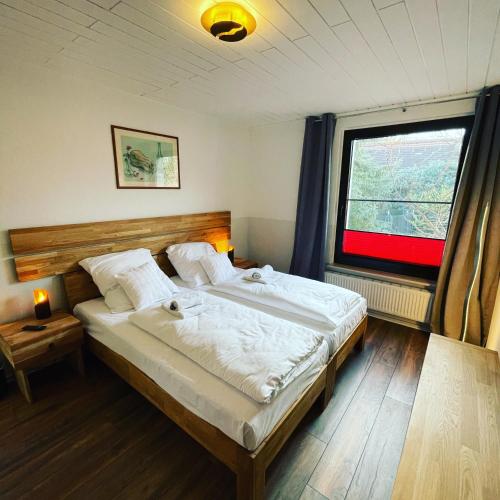a bedroom with a large bed and a window at Appartement Seebadallee mit Klimaanlage und Wallbox für e-Autos in Rangsdorf