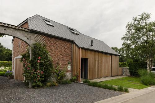 a brick building with a garage at G'Ardenne Blue in Durbuy