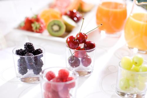a table with several small glasses of fruit on it at Hotel Sonnblick in Lech am Arlberg