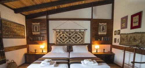 a bedroom with two beds in a room with two lamps at Tritonia in Gaios