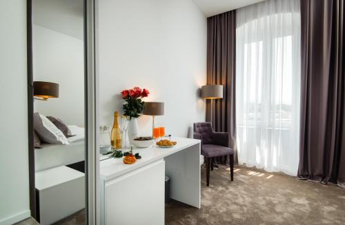a hotel room with a desk and a bed and a window at Dream Luxury Rooms in Split