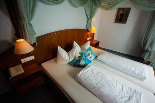 a bed in a hotel room with at Kaiserstühler-Hof in Breisach am Rhein