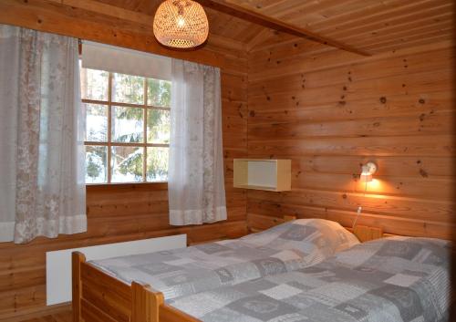 Postel nebo postele na pokoji v ubytování Rinnepelto Holiday Cottages