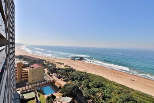 a view of a beach and the ocean from a building at Stella Maris 144 in Amanzimtoti