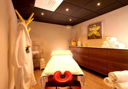 a hospital room with a bed with a red seat at Smygehus Havsbad in Smygehamn