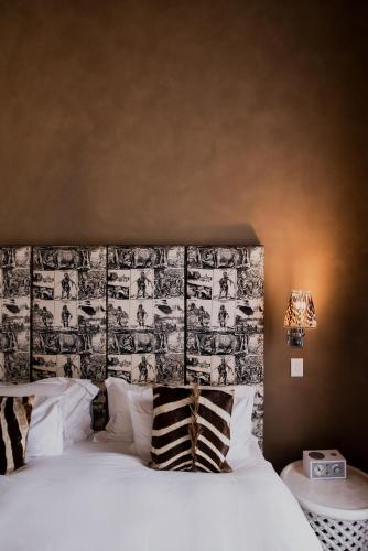 a bedroom with a bed with a black and white headboard at Cape Heritage Hotel in Cape Town