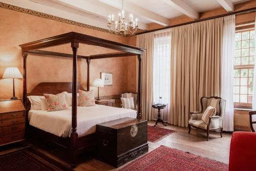 
a bedroom with a large bed and a large window at Cape Heritage Hotel in Cape Town
