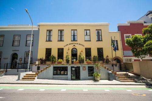 a yellow building with stairs in front of it at Cape Heritage Hotel in Cape Town