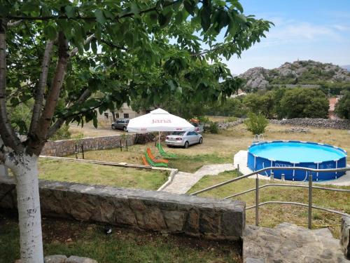 a view of a yard with a pool and a tent at Apartments Nagj in Sveti Juraj