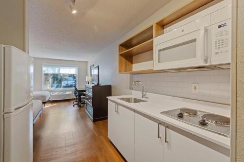a kitchen with white cabinets and a white refrigerator at Extended Stay America Suites - San Jose - Milpitas - McCarthy Ranch in Milpitas