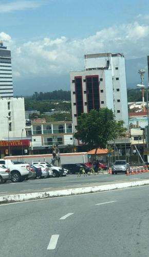 a dog running on the street in a parking lot at Portal Palace Hotel in Aparecida