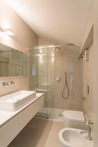 a bathroom with a sink and a toilet and a shower at Villa Belvedere in Salò