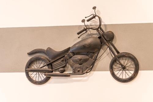 a metal motorcycle is hanging on a wall at 5 terre dei poeti in La Spezia