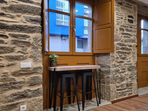 a kitchen with a counter and a window at Casa da Marquesa Sarria in Sarria