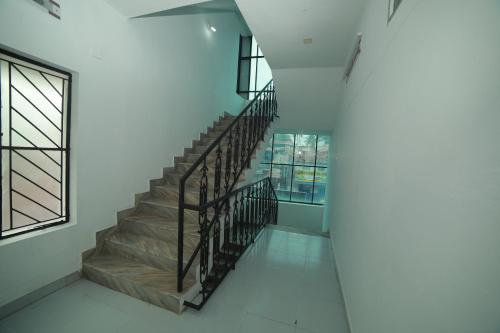 a spiral staircase in a building with a window at MEGHNA RESIDENCY in Trivandrum