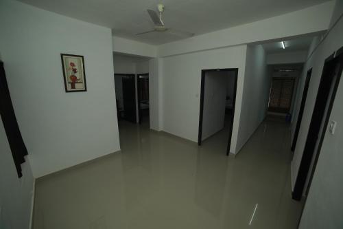 a hallway with white walls and a ceiling at MEGHNA RESIDENCY in Trivandrum