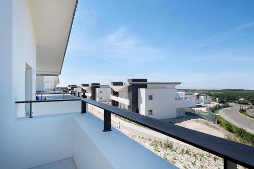 a view from the balcony of a white building at Royal Obidos Scenic Resort in Casal da Lagoa Seca