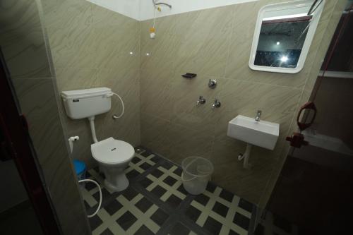 a small bathroom with a toilet and a sink at MEGHNA RESIDENCY in Trivandrum