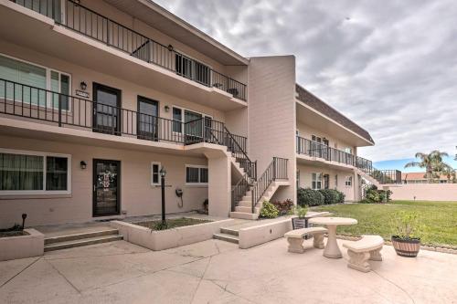 a building with two benches in front of it at Ponce Inlet Condo with Beach and Pool Access! in Ponce Inlet
