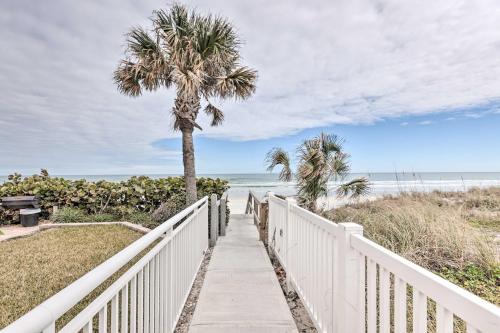 a path to the beach with a palm tree at Ponce Inlet Condo with Beach and Pool Access! in Ponce Inlet
