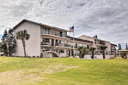 a building with an american flag in front of it at Ponce Inlet Condo with Beach and Pool Access! in Ponce Inlet