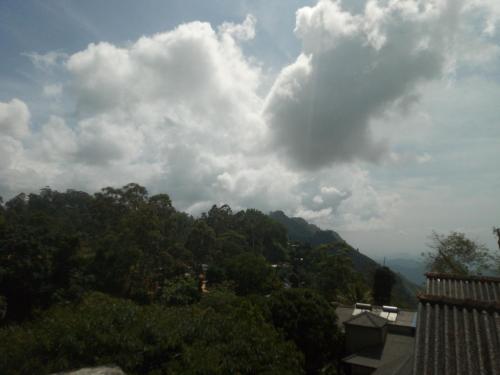 a view of a mountain with trees and clouds at Green View Ella in Ella