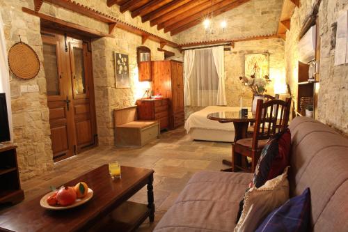 a living room with a couch and a table at Agrovino Lofou in Lofou