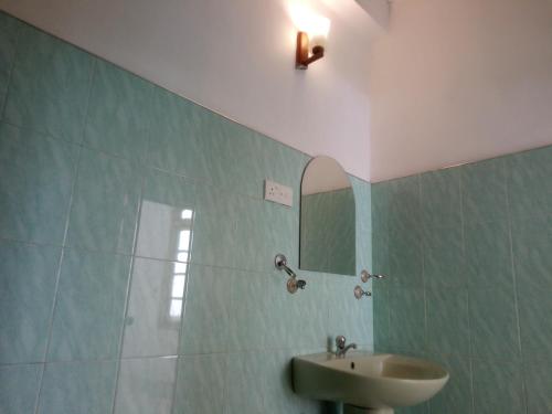 a bathroom with a sink and a mirror at Green View Ella in Ella