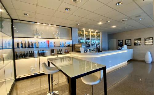 a restaurant with a glass table and two chairs at Barion Hotel & Congressi in Bari
