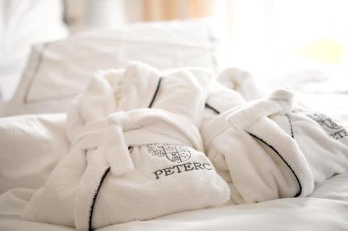 a pile of white towels sitting on top of a bed at Peterc Vineyard Estate in Kojsko