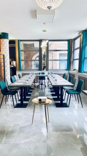 a row of tables and chairs in a room at Best Western Hotel Saint Claude in Péronne