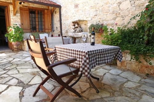 a table with a bottle of wine sitting on it at Agrovino Lofou in Lofou