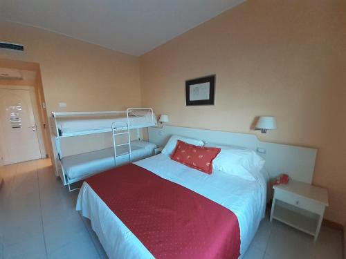 a bedroom with a bed with a red pillow at Barion Hotel & Congressi in Bari