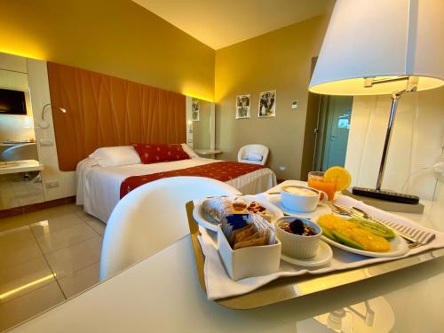 a hotel room with a tray of food on a table at Barion Hotel & Congressi in Bari